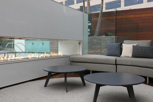 a living room with a couch and two tables at Modern Building - Free Parking - By CHOC & St Joseph in Orange