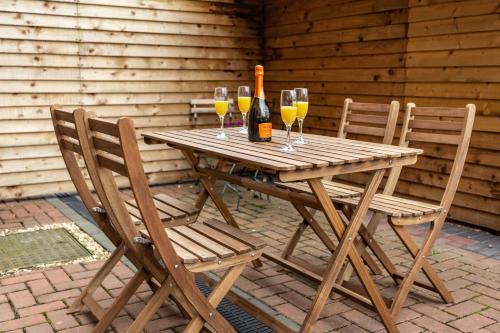 a wooden table with two chairs and a bottle of wine at Cromwell House in Chester