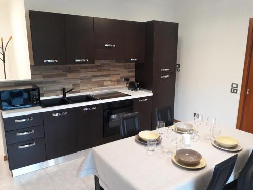 a kitchen with a table with plates and wine glasses at Elite Apartments in Perugia