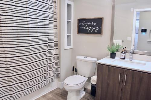 a bathroom with a toilet and a sink at Modern Building - Free Parking - By CHOC & St Joseph in Orange