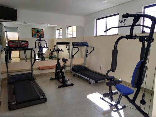 a gym with several tread machines in a room at Esplendor Palace Hotel in Vitória da Conquista