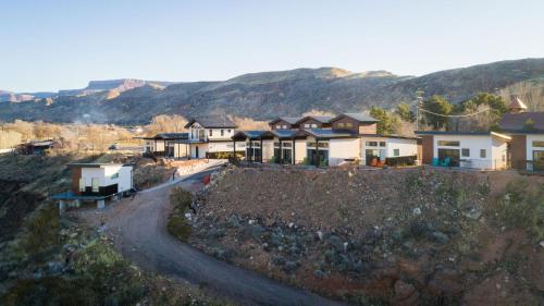 a row of houses on a hill with a dirt road at The Dwellings in La Verkin