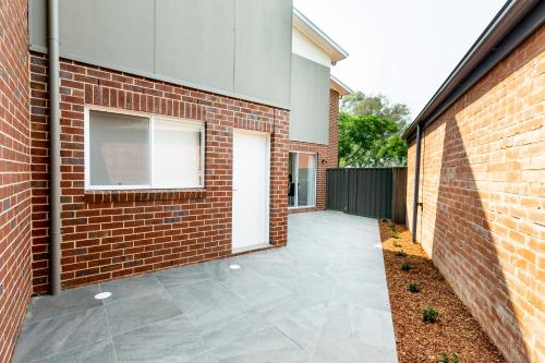 a brick building with a walkway and a window at Wagga Apartments #4 in Wagga Wagga