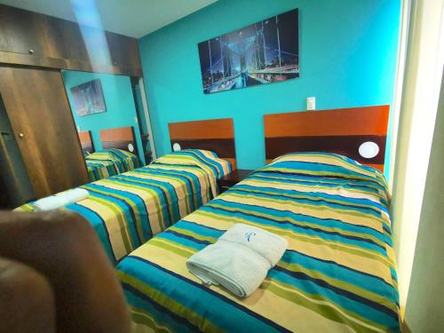 two beds sitting next to each other in a room at Residencial Cafferata in Lima