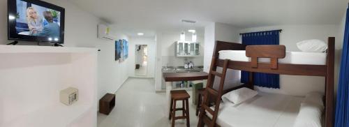 a small room with a bunk bed and a bathroom at Cabañas Aqua Blue in Coveñas