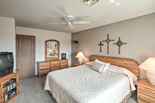 a bedroom with a bed and a flat screen tv at Single-Story Home with Yard, 1 Mi to Windsor Launch! in Lake Havasu City