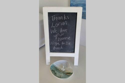 a chalkboard with a sign that says thank london we love your home hope at Sapphire Beach Pet Friendly Beach 5 minute walk in Sapphire Beach