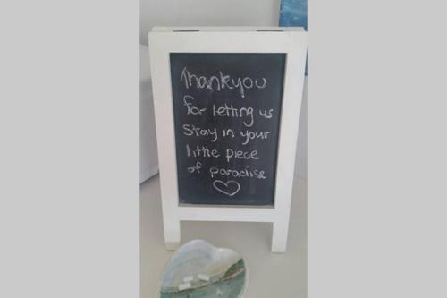 a chalkboard with a sign that says thank you for letting us stay in your at Sapphire Beach Pet Friendly Beach 5 minute walk in Sapphire Beach