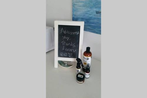 a refrigerator with two bottles of wine next to a chalkboard at Sapphire Beach Pet Friendly Beach 5 minute walk in Sapphire Beach