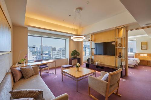 a living room with a couch and a table at THE KITANO HOTEL TOKYO in Tokyo