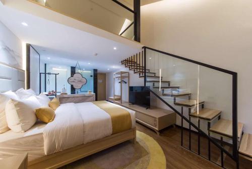 a bedroom with a large bed and a staircase at Mengjing Xiyue Hotel in Kunming