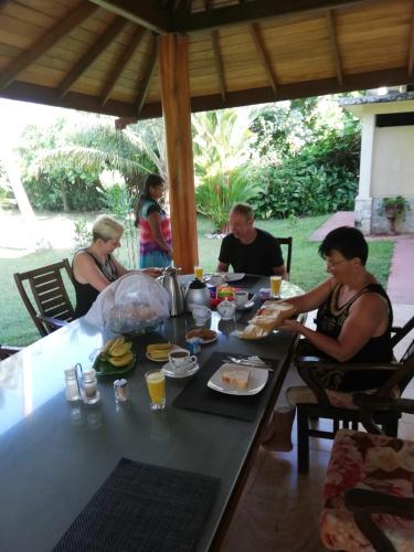 a group of people sitting at a table eating food at Zum Deutschen in Bentota