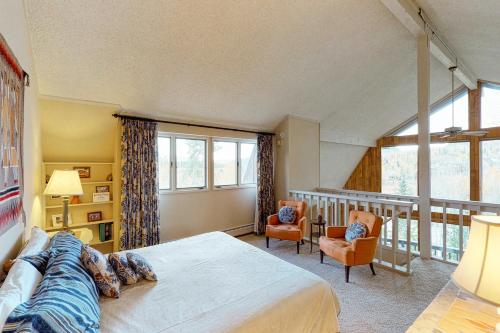 a bedroom with a large bed and a balcony at Wildflowers Chalet in Silverthorne
