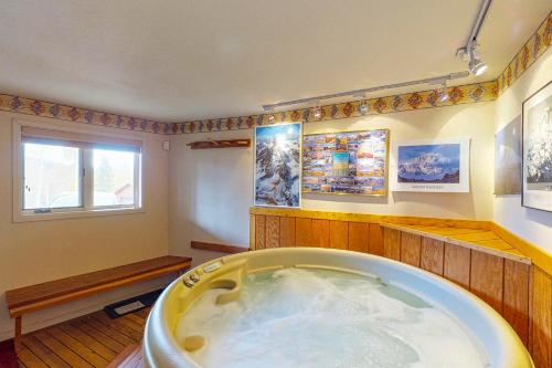 a large bath tub in a room with a window at Wildflowers Chalet in Silverthorne