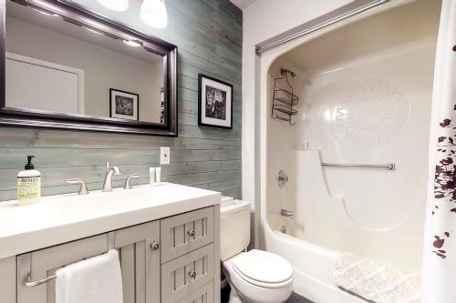 a bathroom with a sink and a toilet and a mirror at Aspenwood 4220 in Pagosa Springs