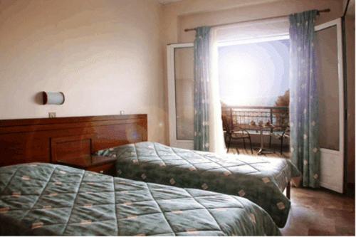 Postel nebo postele na pokoji v ubytování Akrogiali