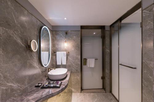 a bathroom with a sink and a mirror at Mercure Xi'an Downtown in Xi'an