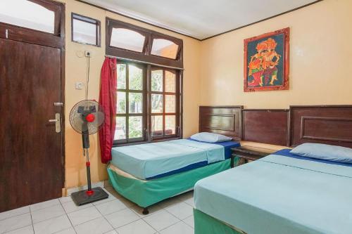 Ένα ή περισσότερα κρεβάτια σε δωμάτιο στο Mahendra Beach Inn