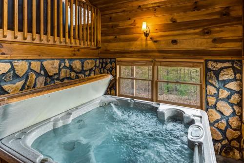 a jacuzzi tub in a log cabin at Picabo in Blue Ridge