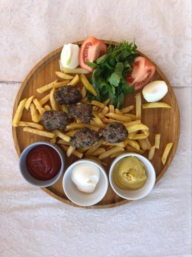 a plate of food with hamburgers and french fries at yenivadi in Antalya