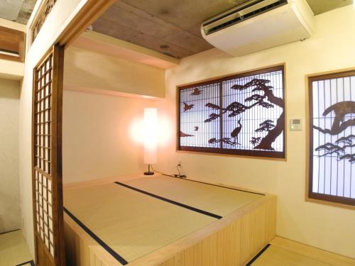 a room with a bed in it with a window at Shibuya神宮前 DAICHI&SOTEN in Tokyo