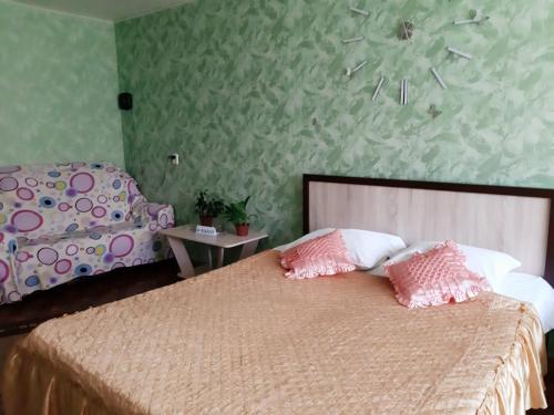 1 dormitorio con 1 cama con almohadas rosas y blancas en 1 комн.Центр,Ж/Д Вокзал, en Volgograd