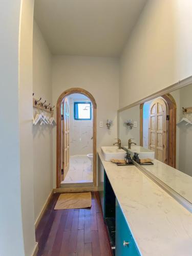 a bathroom with two sinks and a large mirror at Lacasa May in Da Lat