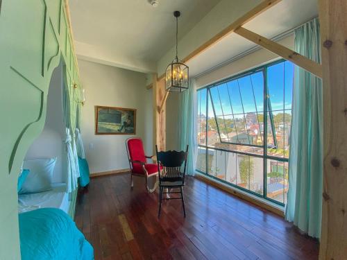 a bedroom with a bed and a large window at Lacasa May in Da Lat