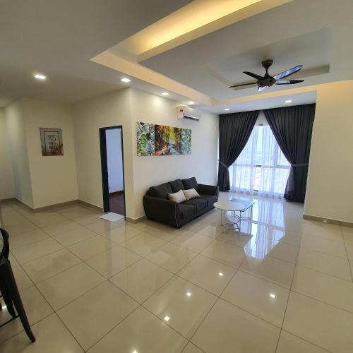 a living room with a couch and a ceiling fan at DaMen Homestay @SubangHomeStay in Subang Jaya