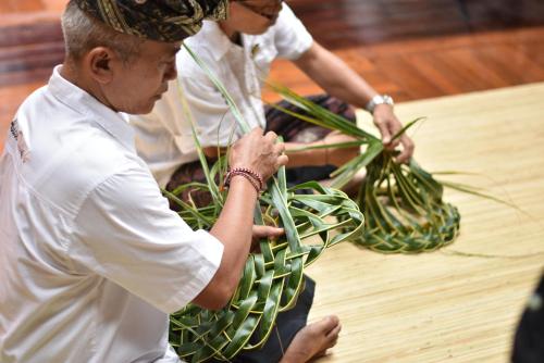 two men working on a plant in a table at The Ayodya Palace in Nusa Dua