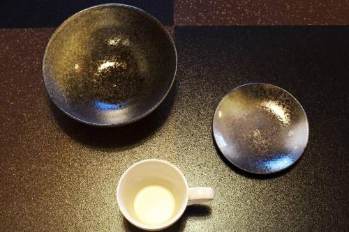 two metal bowls and a cup of milk on a counter at GOURA TERRACE in Gora