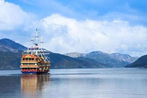 a boat on the water with mountains in the background at GOURA TERRACE in Gora