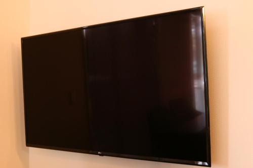 a flat screen television hanging on a wall at SILVER SPRAY MtFuji view Yamanakako in Yamanakako