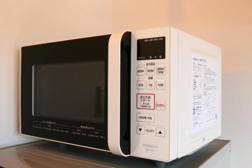a microwave oven sitting on top of a shelf at SILVER SPRAY MtFuji view Yamanakako in Yamanakako