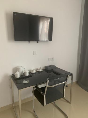 Télévision ou salle de divertissement dans l'établissement Feima Hotel