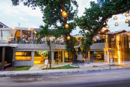 a building with people sitting on top of it at FuramaXclusive Ocean Beach Seminyak Bali in Legian