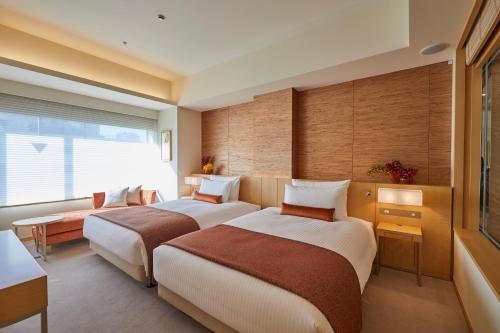 a hotel room with two beds and a window at THE KITANO HOTEL TOKYO in Tokyo