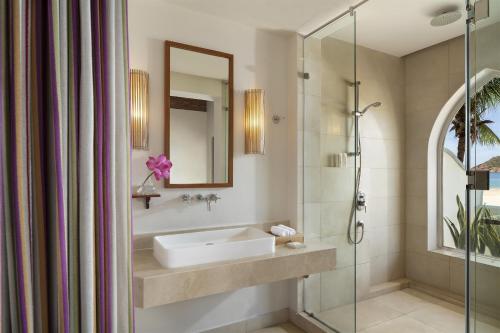 a bathroom with a sink and a shower at Avani Quy Nhon Resort in Quy Nhon