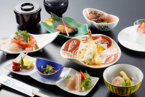 a group of plates of food on a table at Fukuno Town Hotel A・Mieux in Nanto
