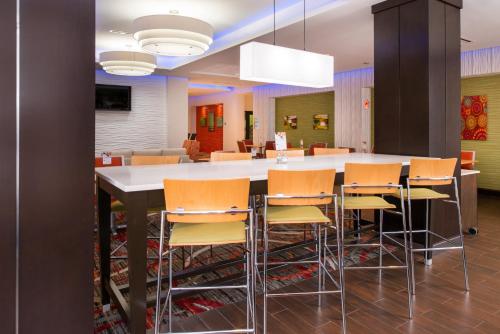 a large kitchen with a large table and chairs at Holiday Inn Express & Suites Monroe by IHG in Monroe