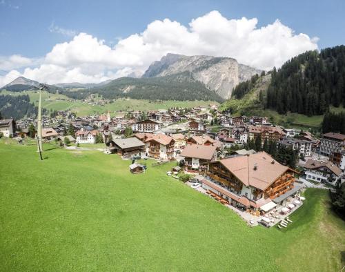 an aerial view of a village in the mountains at Freina Mountain Lifestyle Hotel in Selva di Val Gardena