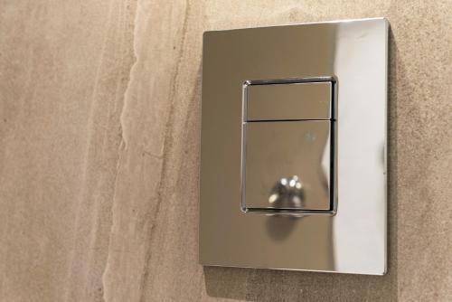 a lightswitch on a wall with a door at Rainbow Towers Hotel & Conference Centre in Harare