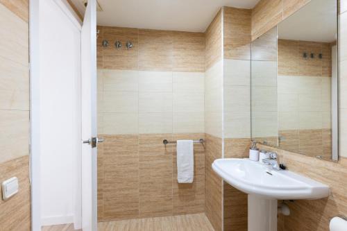 a bathroom with a sink and a shower at matarolux18 in Mataró