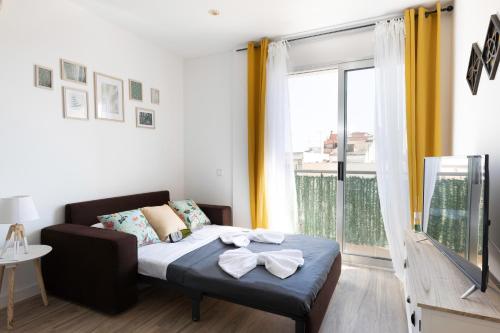 a bedroom with a bed and a large window at matarolux18 in Mataró