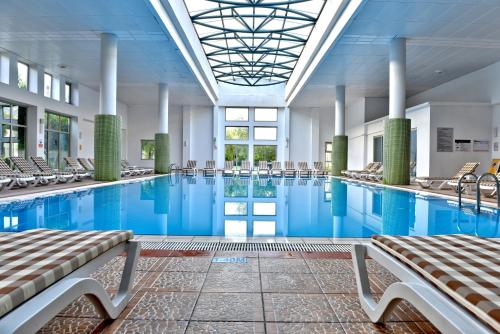 a large swimming pool with chairs in a building at TUI BLUE Tropical in Dalaman