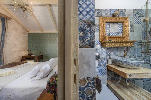a bathroom with a bed and a sink in a room at Villa Perina Biograd, something completely different in Biograd na Moru