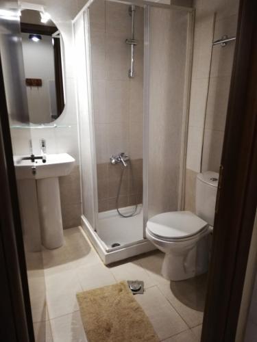 a bathroom with a shower and a toilet and a sink at Guesthouse Axieros in Samothraki