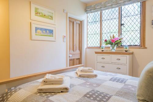 a room with a table with towels on it at Hockley House by Bloom Stays in Folkestone