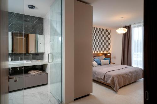 a bedroom with a bed and a bathroom with a mirror at Villa Eola Hvar in Jelsa