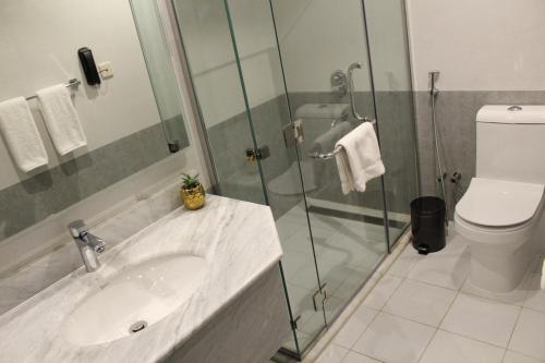 a bathroom with a sink and a glass shower at Holiday Villa Hail in Hail
